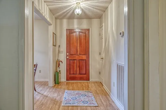 a view of a hallway with a chandelier