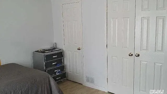 a bedroom with a bed and a cabinets