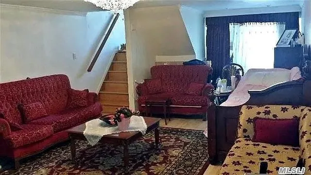 a living room with furniture rug and window