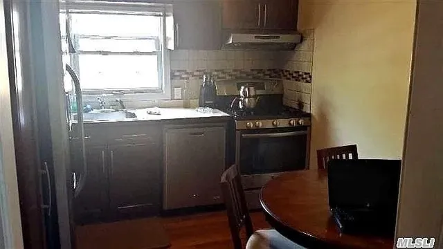 a kitchen with a stove and a refrigerator