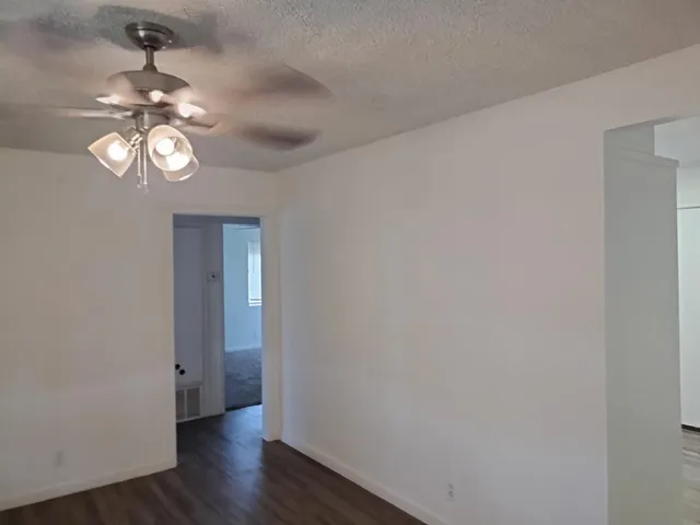 a view of a room with wooden floor and chandelier