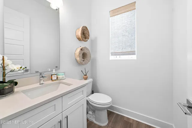 a bathroom with a toilet a sink and mirror