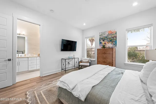 a bedroom with a bed and a flat screen tv