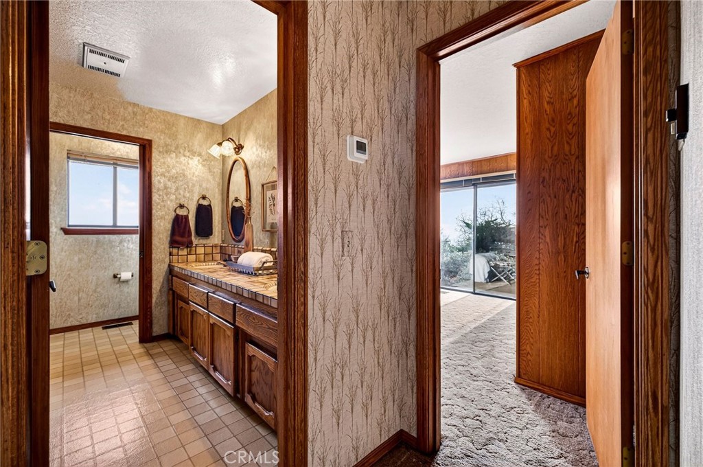 4139 Hidden Valley Road Butte Valley, CA 95965 - Photo 20 of 75 a bathroom with a double vanity sink and mirror