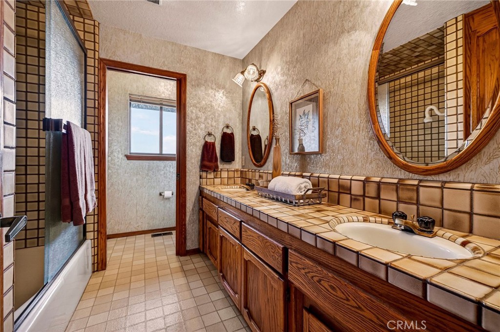 4139 Hidden Valley Road Butte Valley, CA 95965 - Photo 24 of 75 a bathroom with a double vanity sink and a mirror