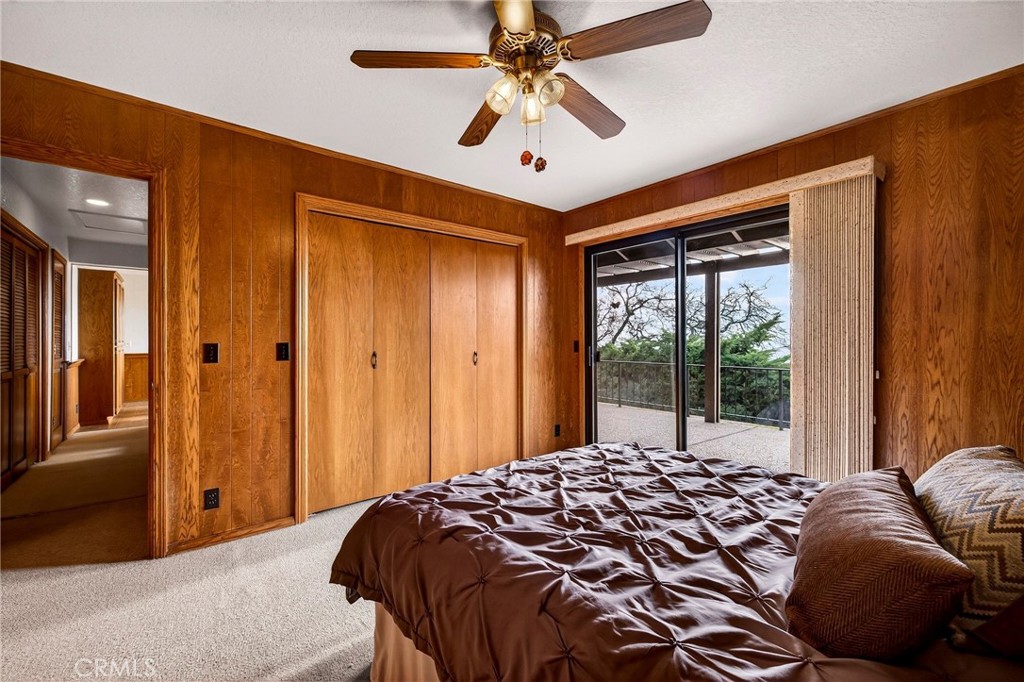 4139 Hidden Valley Road Butte Valley, CA 95965 - Photo 32 of 75 a bedroom with a large bed and a chandelier fan