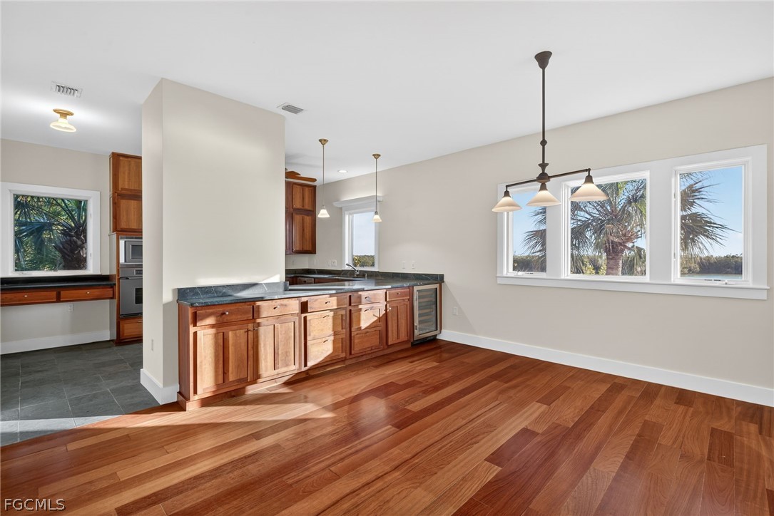 5703 Sanibel Captiva Road Sanibel, FL 33957 - Photo 19 of 50 a open kitchen with stainless steel appliances granite countertop a stove a sink and a wooden floors