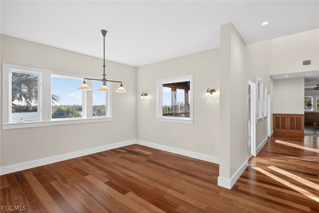 5703 Sanibel Captiva Road Sanibel, FL 33957 - Photo 20 of 50 a view of an empty room with wooden floor and a window