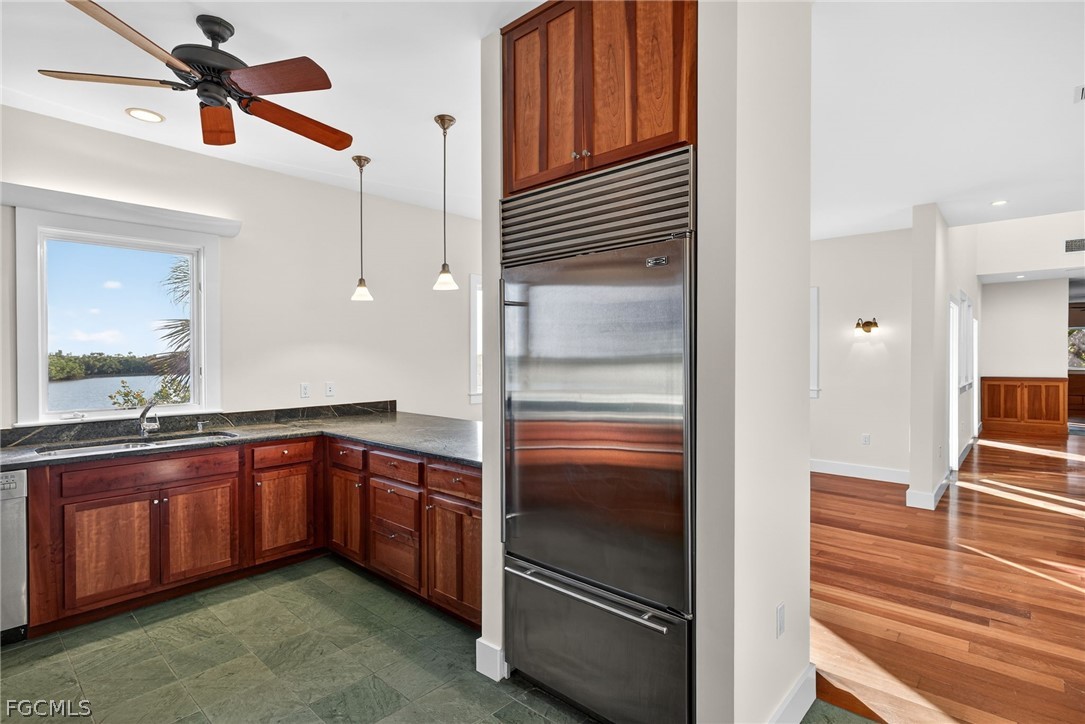 5703 Sanibel Captiva Road Sanibel, FL 33957 - Photo 22 of 50 a kitchen with granite countertop stainless steel appliances and wooden cabinets