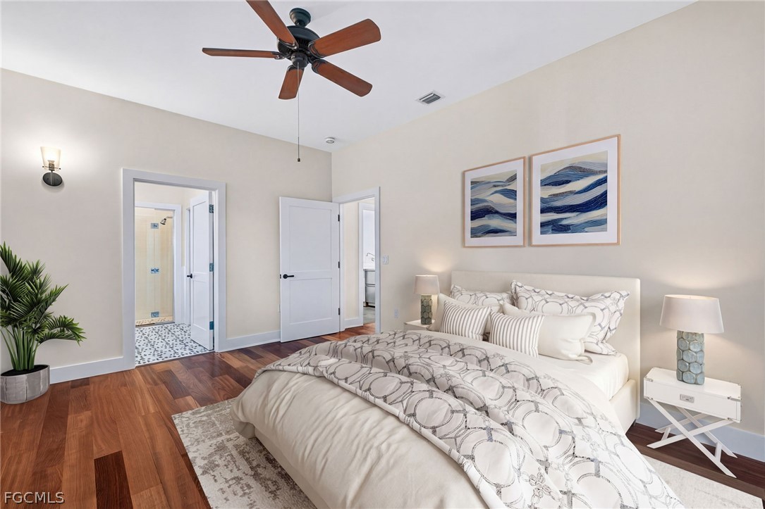 5703 Sanibel Captiva Road Sanibel, FL 33957 - Photo 28 of 50 a bedroom with a large bed and a chandelier