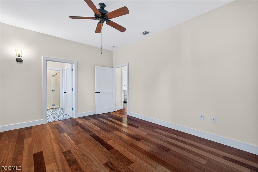 5703 Sanibel Captiva Road Sanibel, FL 33957 - Photo 30 of 50 an empty room with wooden floor and windows
