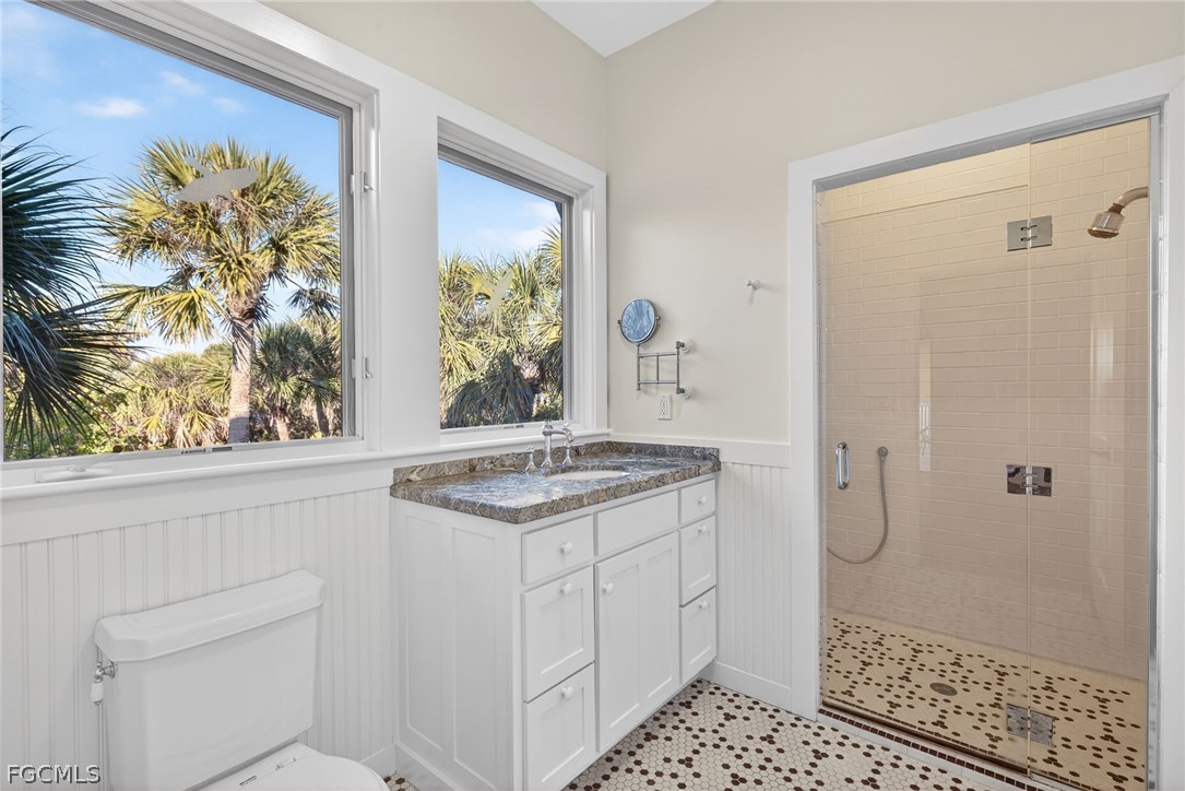 5703 Sanibel Captiva Road Sanibel, FL 33957 - Photo 31 of 50 a bathroom with a sink a vanity and a shower