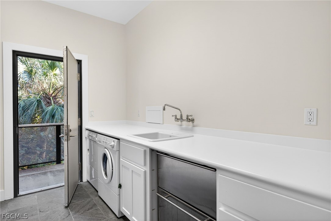 5703 Sanibel Captiva Road Sanibel, FL 33957 - Photo 37 of 50 a utility room with a sink dryer and washer