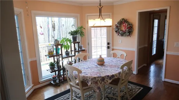 a view of a dining room with furniture window and wooden floor