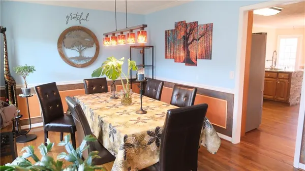 a view of a dining room with furniture and wooden floor
