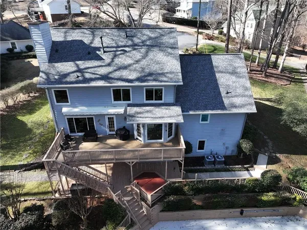 an aerial view of a house with yard table and chairs