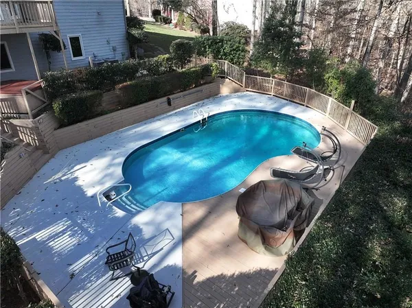 a view of a swimming pool with a yard