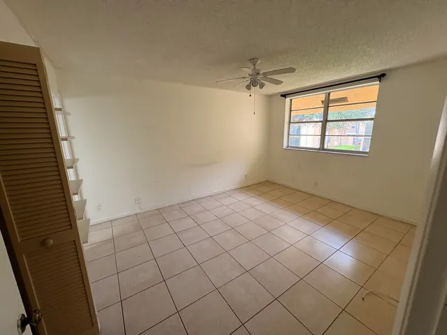 a view of a livingroom with an empty space and a ceiling fan