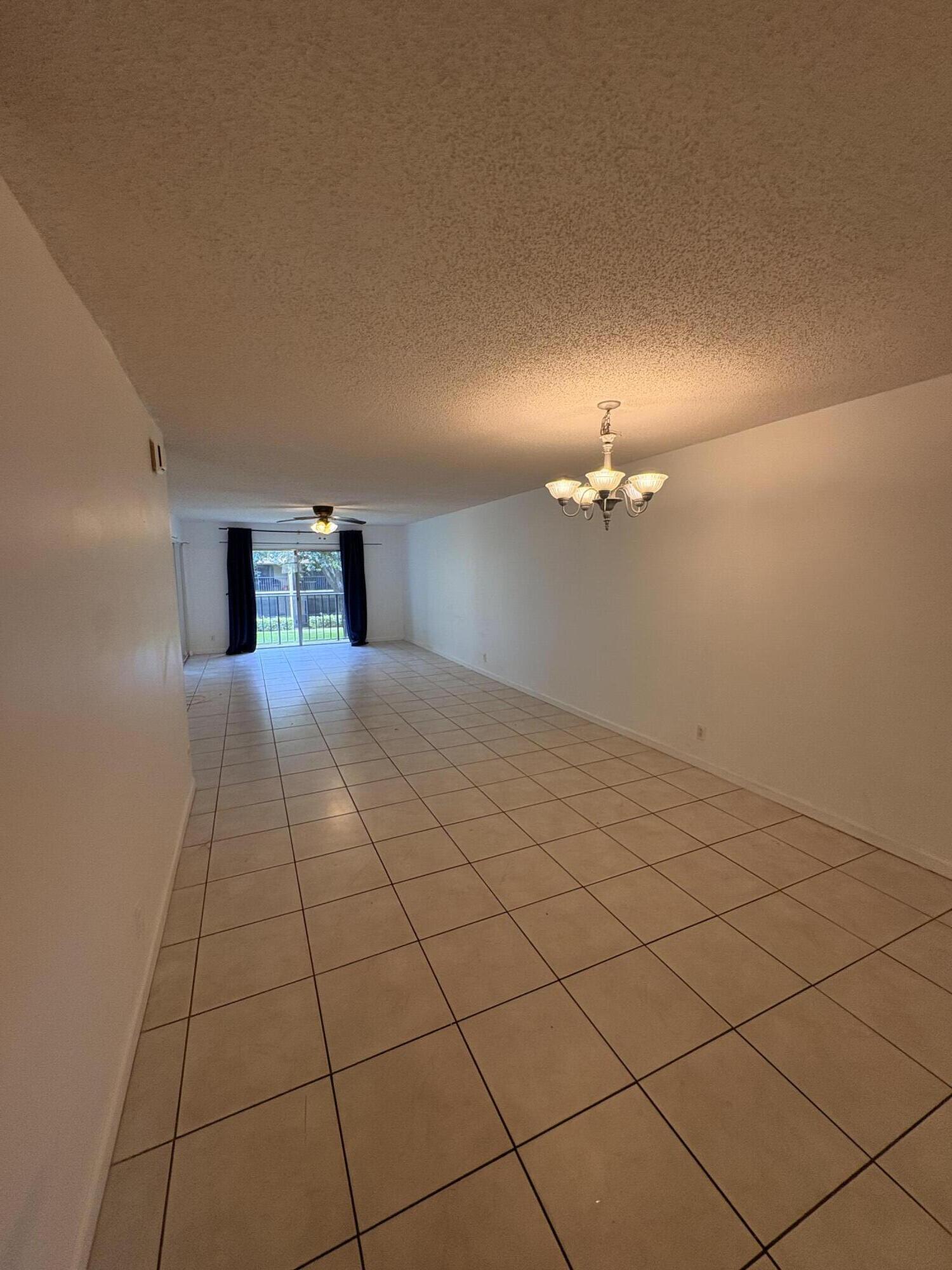 2925 Southwest 22nd Avenue, Unit 202 Delray Beach, FL 33445 - Photo 2 of 14 a view of an empty room with a window