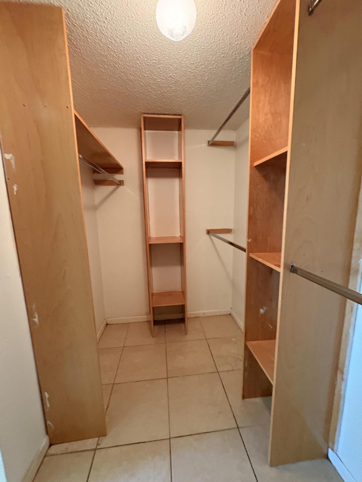 2925 Southwest 22nd Avenue, Unit 202 Delray Beach, FL 33445 - Photo 10 of 14 a view of walk in closet with empty racks