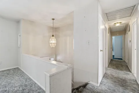 a view of a hallway with entryway door