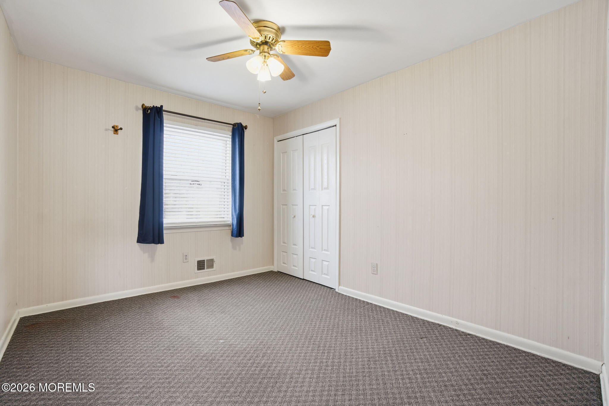 708 Auth Avenue Oakhurst, NJ 07755 - Photo 4 of 29 an empty room with windows and fan