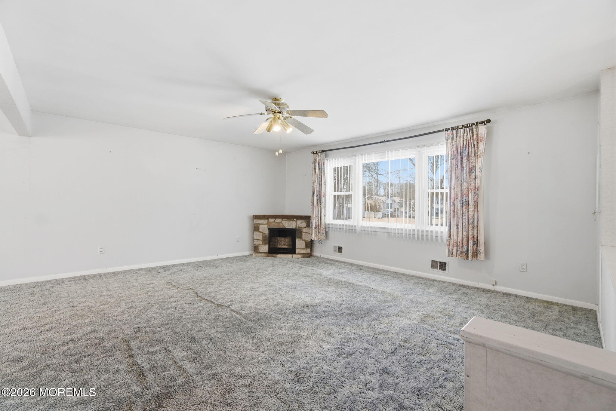 708 Auth Avenue Oakhurst, NJ 07755 - Photo 9 of 29 an empty room with fireplace and windows