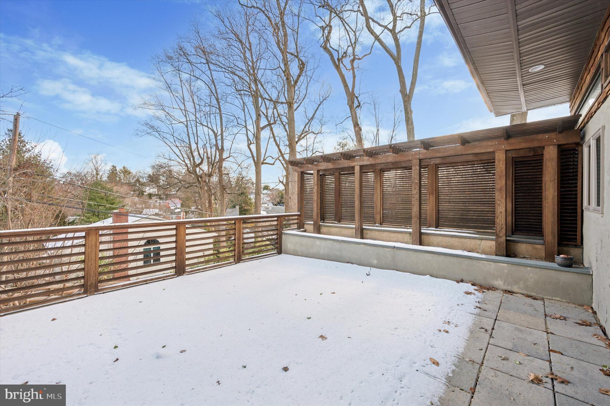 29 Rolling Road Wynnewood, PA 19096 - Photo 13 of 25 a view of a roof deck with wooden fence and large trees