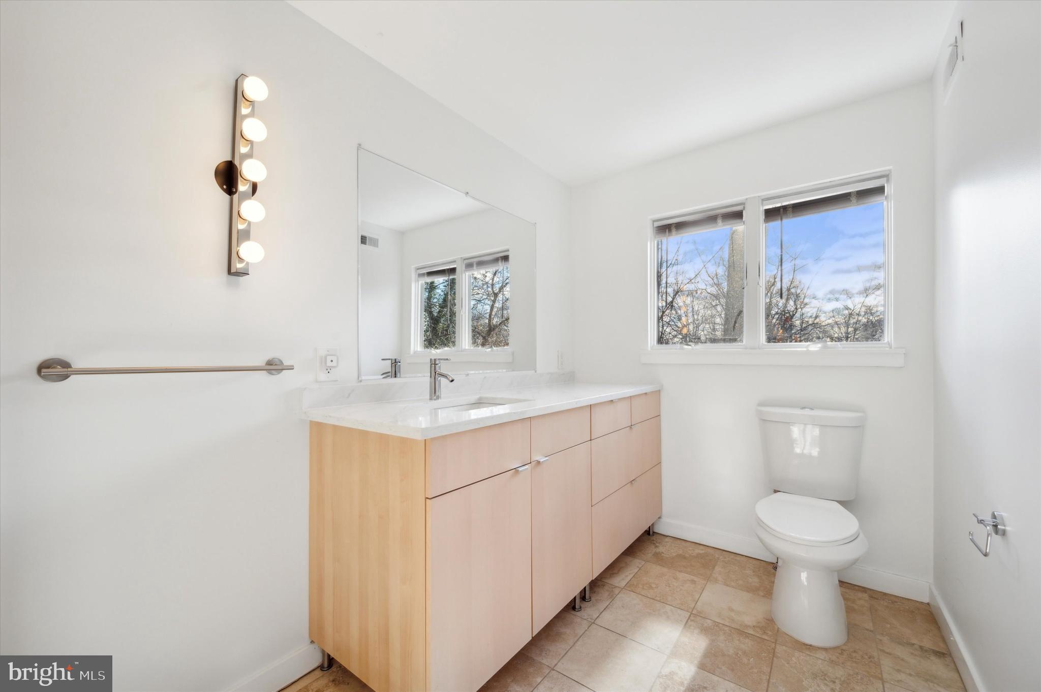 29 Rolling Road Wynnewood, PA 19096 - Photo 16 of 25 a bathroom with a toilet sink and mirror