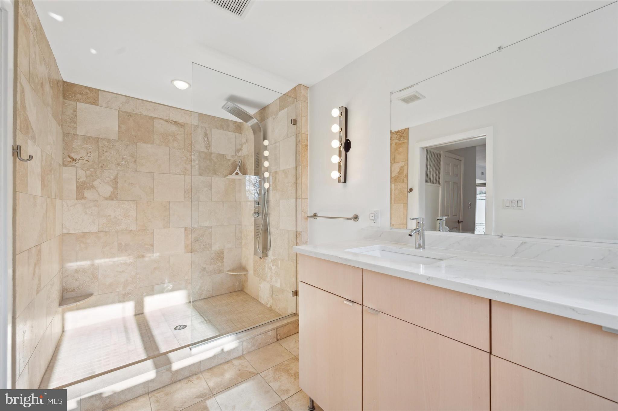 29 Rolling Road Wynnewood, PA 19096 - Photo 17 of 25 a bathroom with a shower sink and mirror