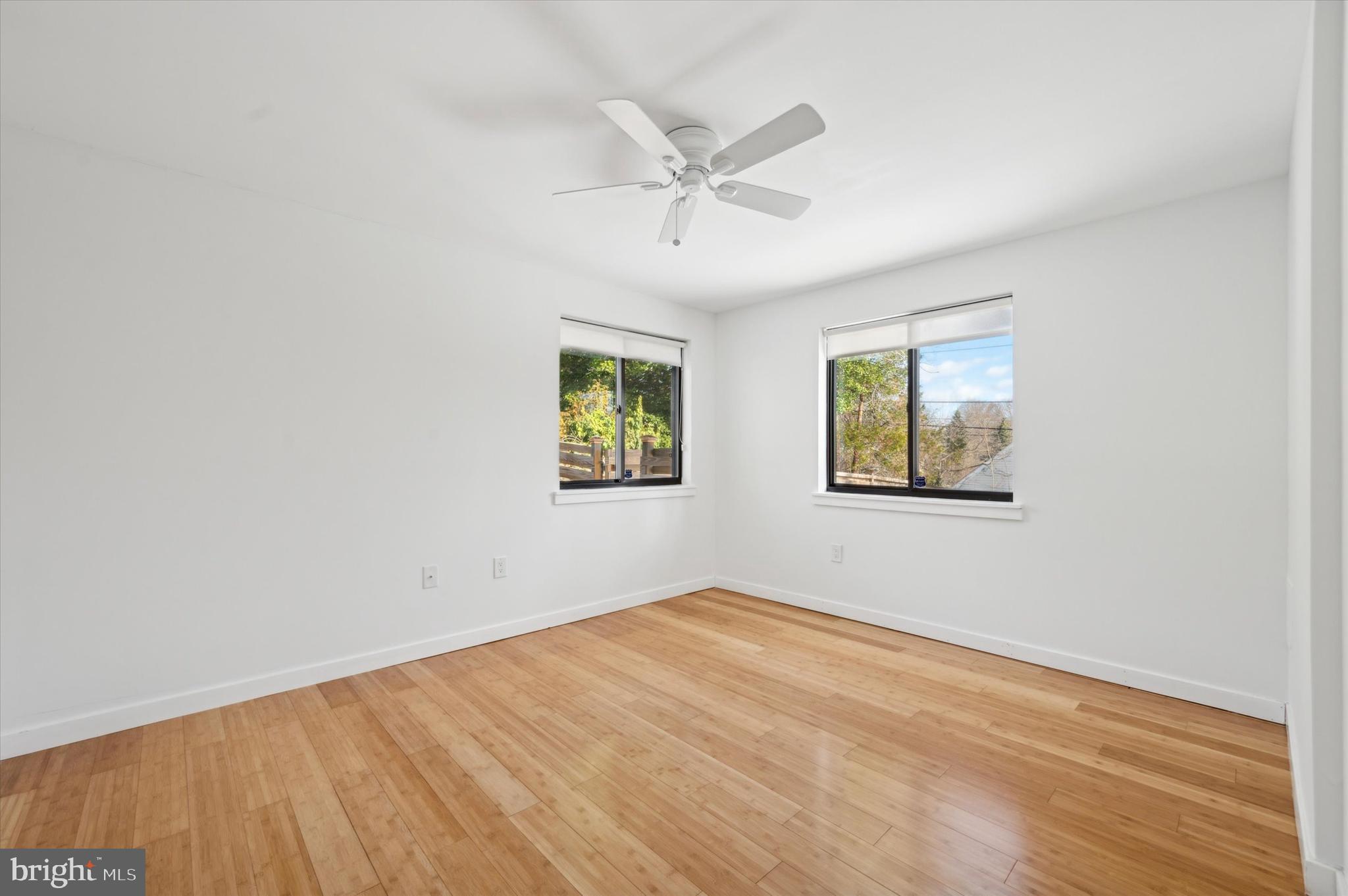 29 Rolling Road Wynnewood, PA 19096 - Photo 24 of 25 an empty room with wooden floor and windows