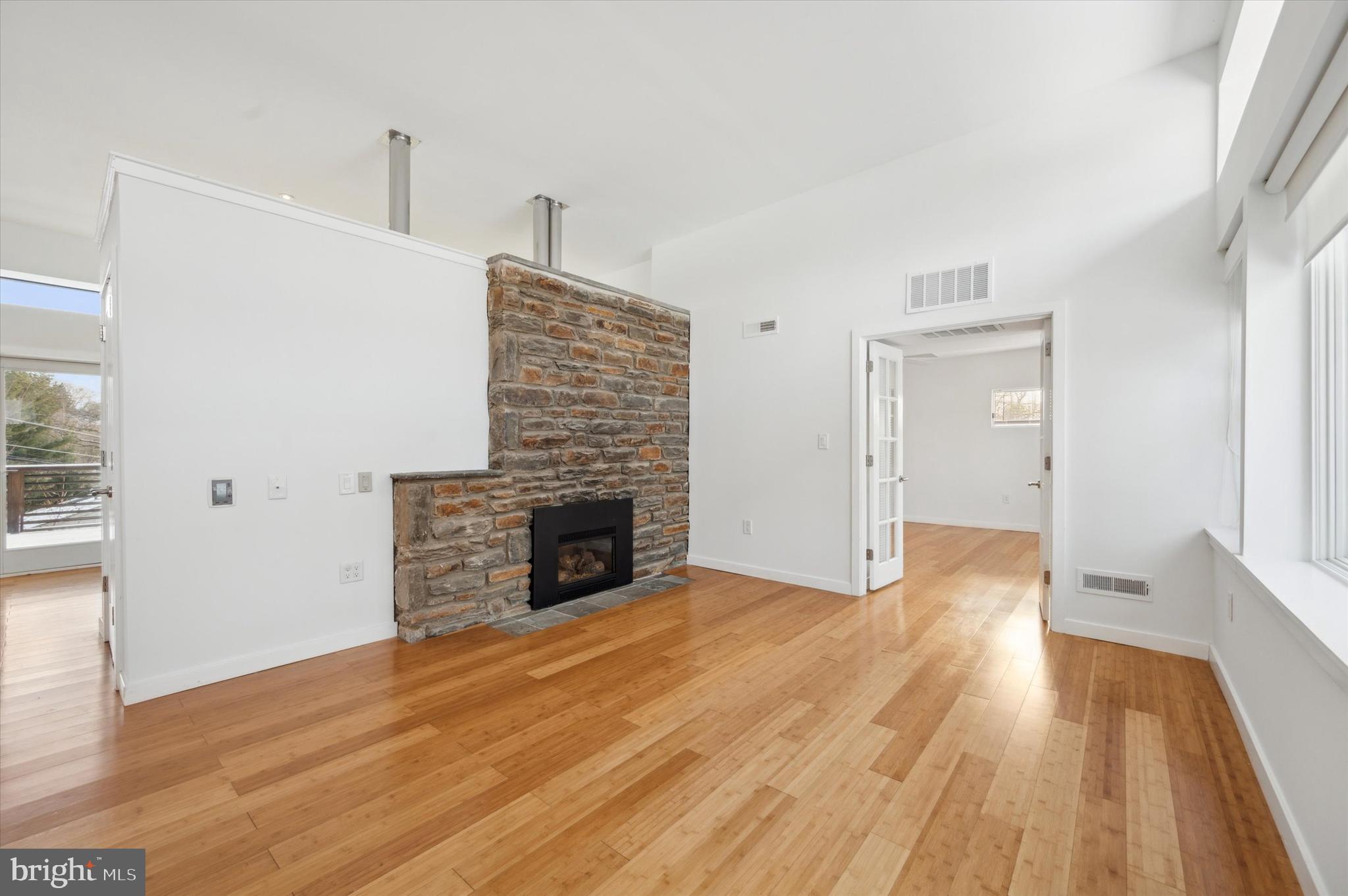 29 Rolling Road Wynnewood, PA 19096 - Photo 4 of 25 a view of empty room with wooden floor fireplace and window
