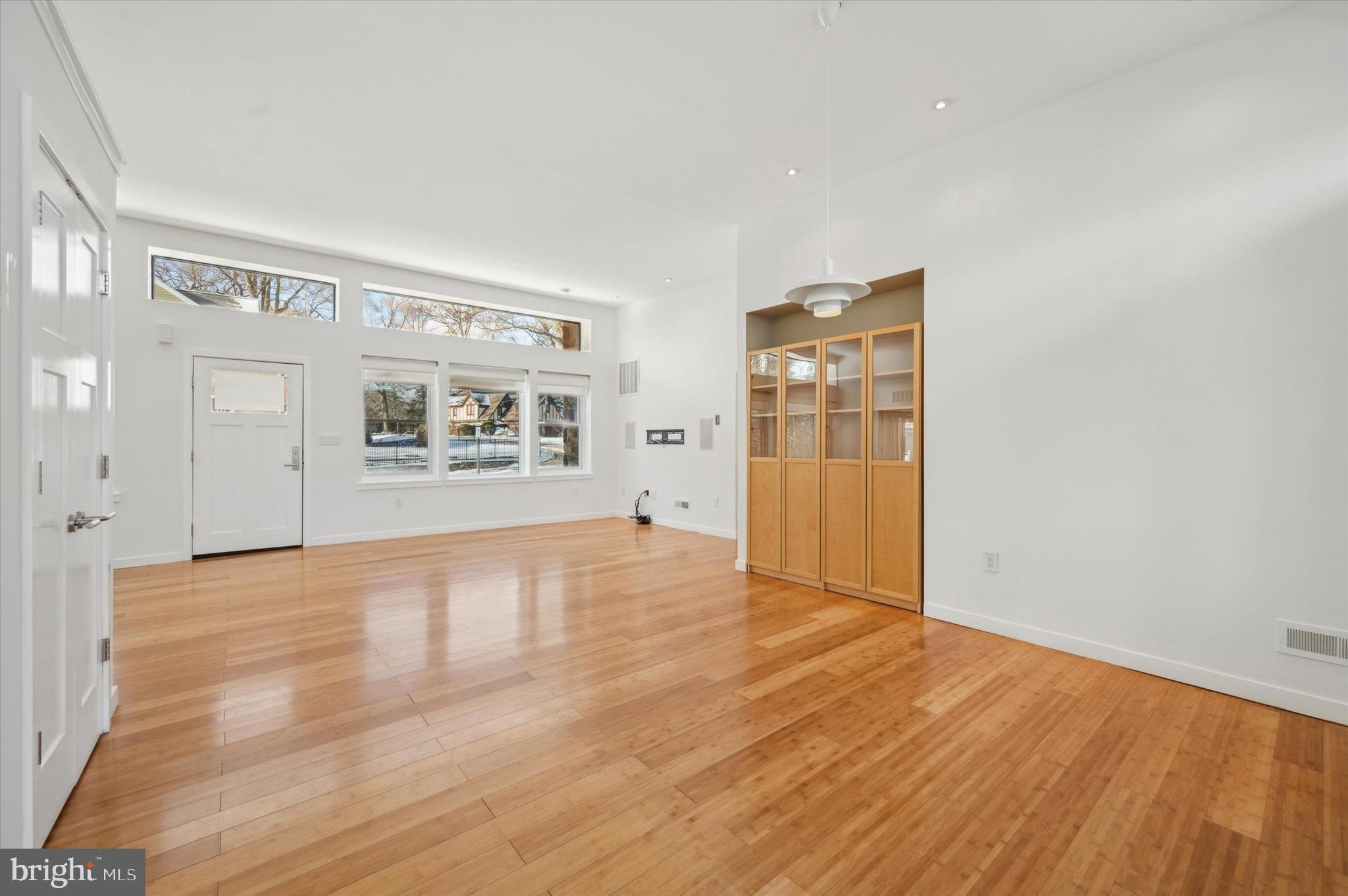 29 Rolling Road Wynnewood, PA 19096 - Photo 7 of 25 a view of an empty room with a window and wooden floor