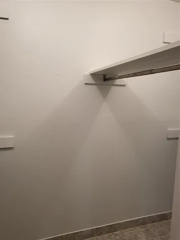 a view of storage and utility room with wooden floor