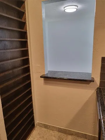 a metallic refrigerator freezer sitting inside of a kitchen