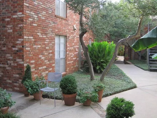 a front view of a house with garden and plants
