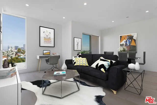 a living room with furniture and a potted plant