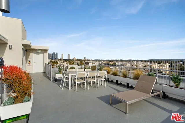 a terrace with outdoor seating and city view