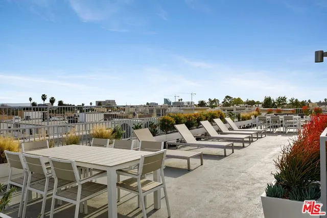 a terrace with outdoor seating and city view