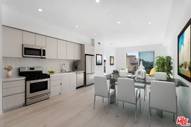 a view of kitchen with microwave stove top oven and cabinets