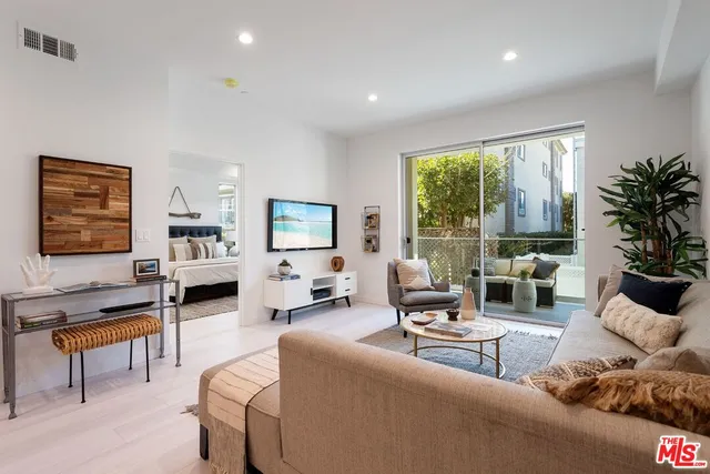 a living room with furniture and large windows