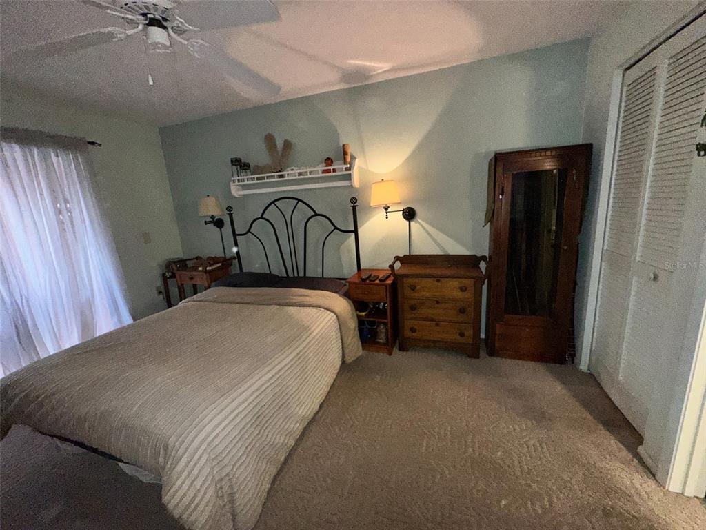 2829 74th Street West, Unit 2829 Bradenton, FL 34209 - Photo 11 of 27 a bedroom with a bed dresser and a window
