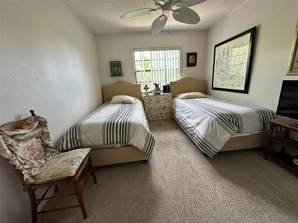 2829 74th Street West, Unit 2829 Bradenton, FL 34209 - Photo 14 of 27 a bedroom with bed couch and window