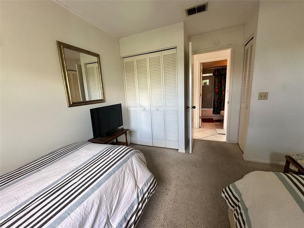 2829 74th Street West, Unit 2829 Bradenton, FL 34209 - Photo 15 of 27 a bedroom with a bed and wooden floor