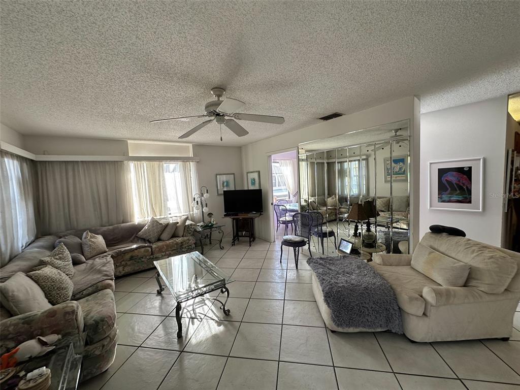 2829 74th Street West, Unit 2829 Bradenton, FL 34209 - Photo 5 of 27 a living room with furniture and a window