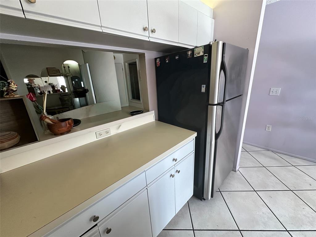 2829 74th Street West, Unit 2829 Bradenton, FL 34209 - Photo 7 of 27 a kitchen with a refrigerator and a sink