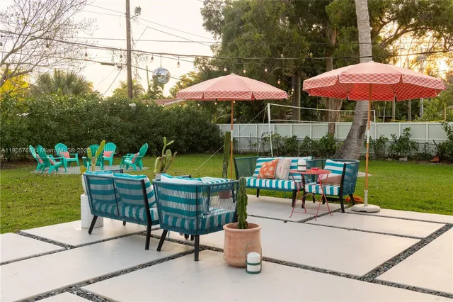 a patio with a table and chairs under an umbrella