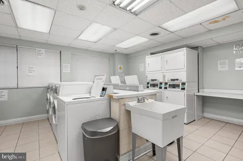 a kitchen with a sink a stove cabinets and counter space
