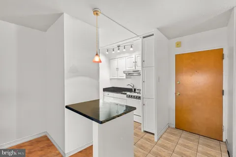 a kitchen with stainless steel appliances granite countertop a sink and a refrigerator