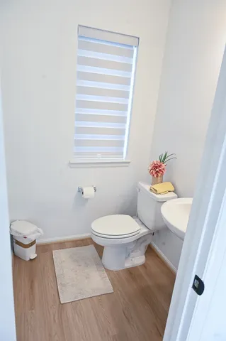 a white toilet sitting next to a bathroom sink and vanity